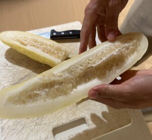 A large yellow cucumber cut in half lengthwise