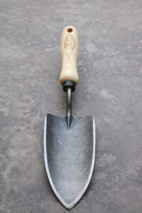 A steel forged trowel with a wooden handle