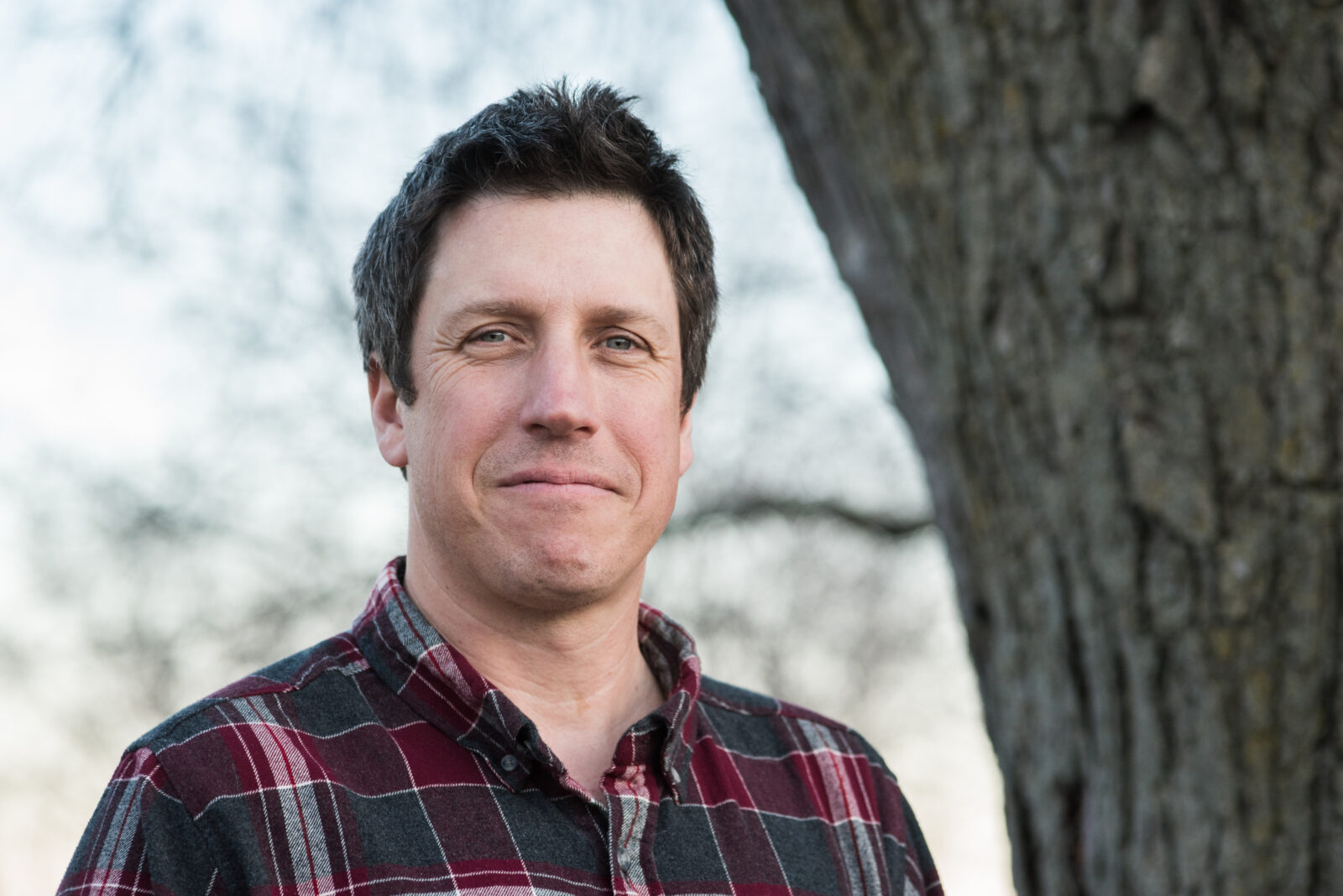 Man next to a tree.