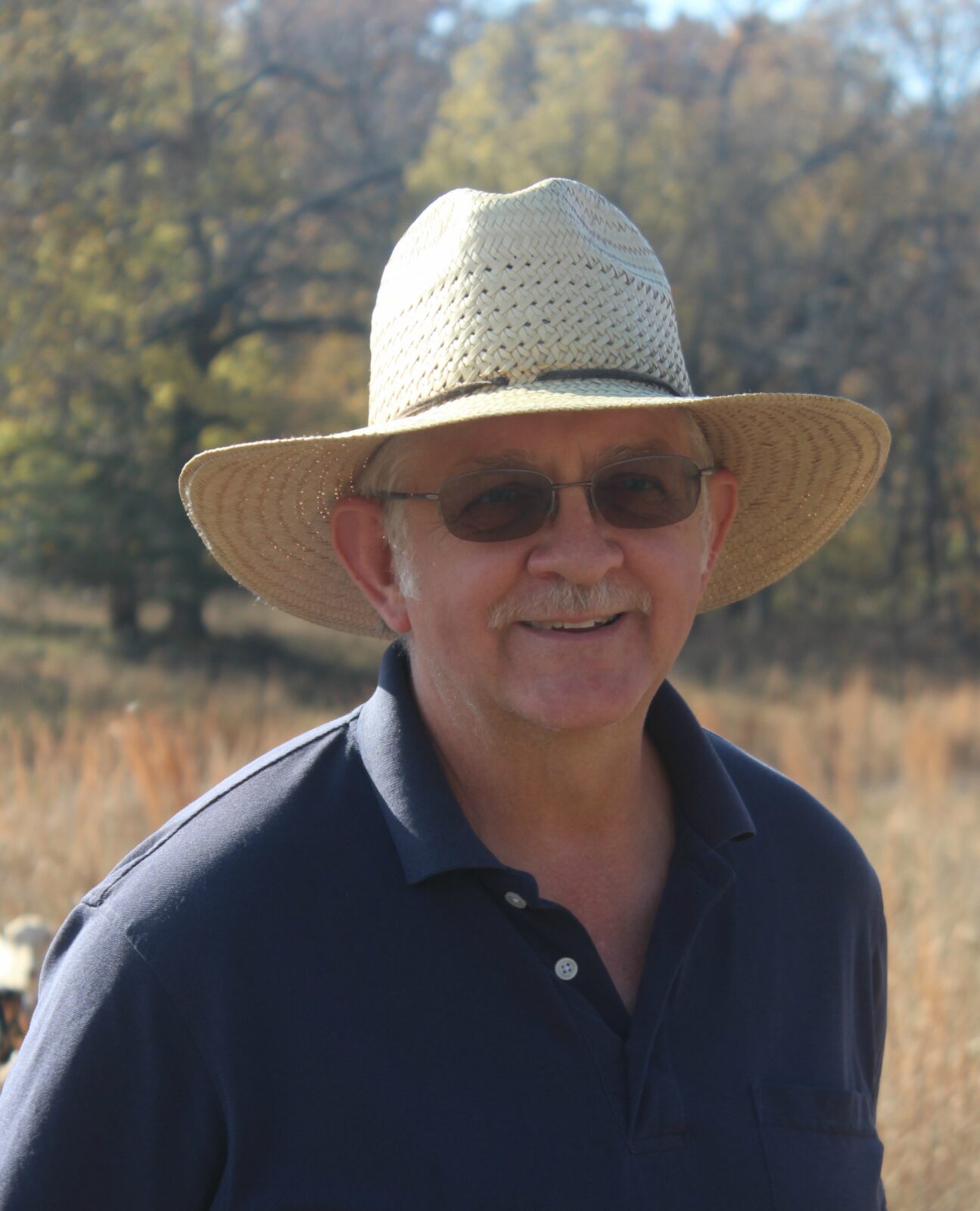 Man in a hat with sunglasses.