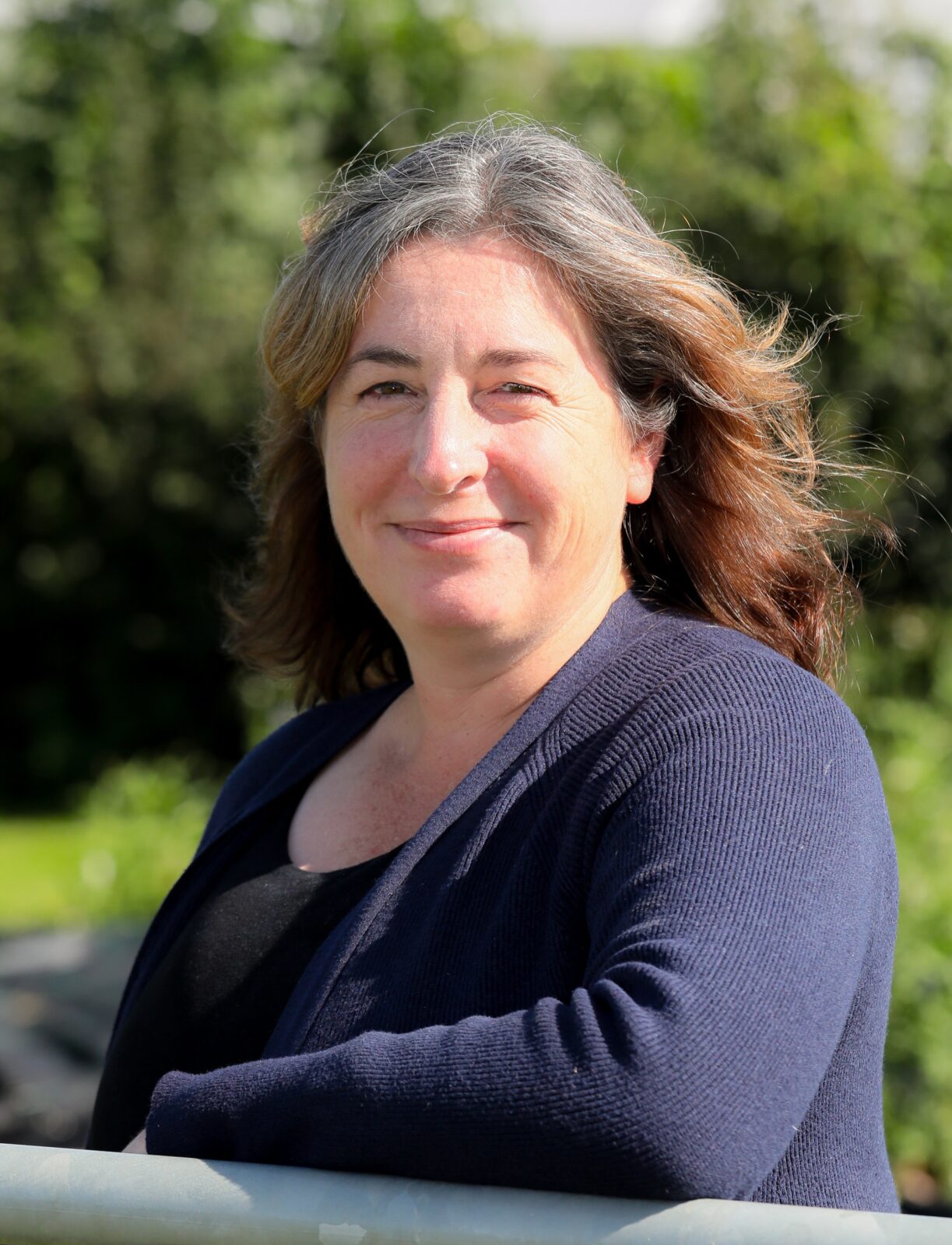 A woman smiles to camera.