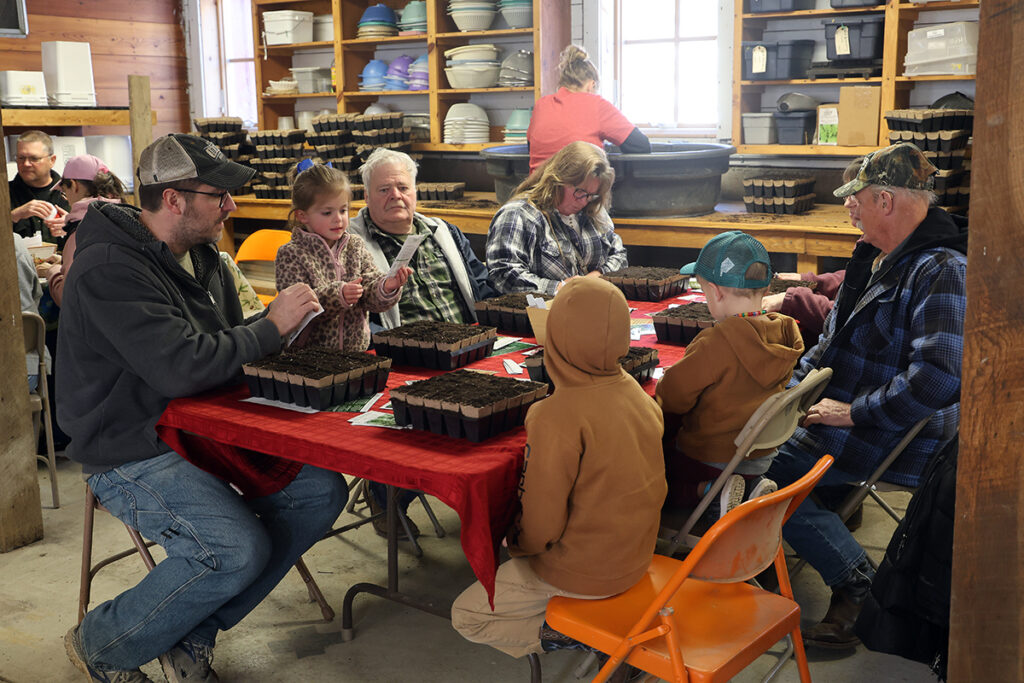 A seed starting class with a mix of ages from children to adults.