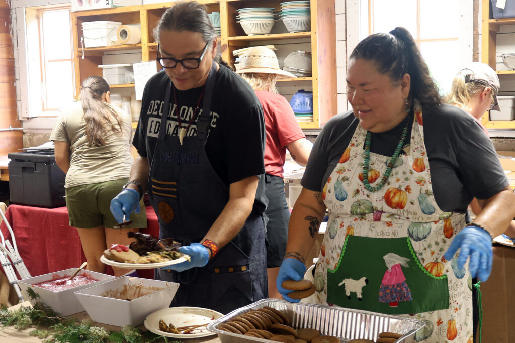 Chef Sean Sherman (left) and Linda Black Elk serve up lunch catered by Sherman’s restaurant, Owamni, and NATIFS during the 50th-anniversary celebration at Heritage Farm. Sherman and Black Elk also teamed up for a keynote during the event.